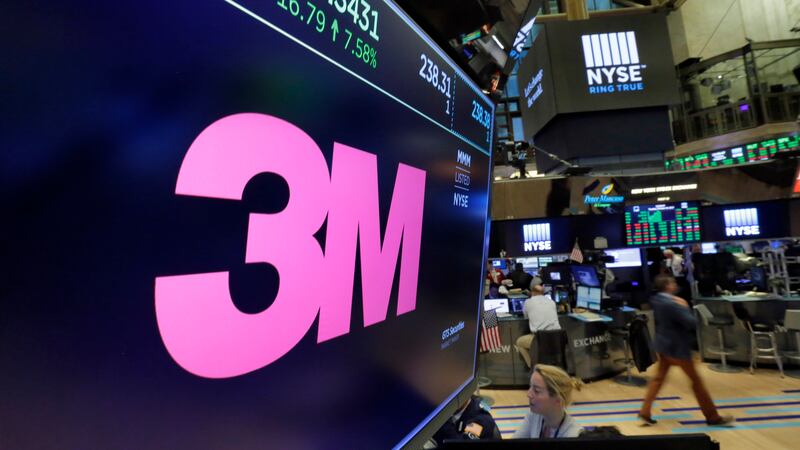FILE - The logo for 3M appears on a screen above the trading floor of the New York Stock...