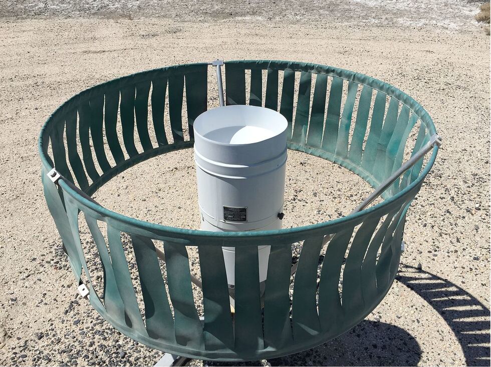 Example of what a heated tipping bucket precipitation gauge looks like. The green screen you...