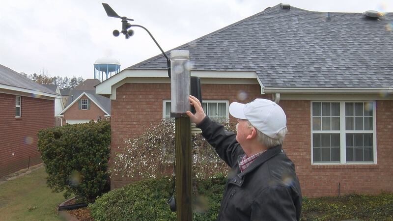 CoCoRaHS volunteer Richard Cutright checks the rain gauge behind his home in Grovetown, GA....